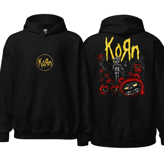 Black pullover hoodie shown from the front and back. The front features a small yellow Korn logo on the left chest, and the back features a large graphic with the word 'Korn' in yellow, a dark figure, and several red cartoon bear faces with glowing yellow eyes, all on a light gray background.