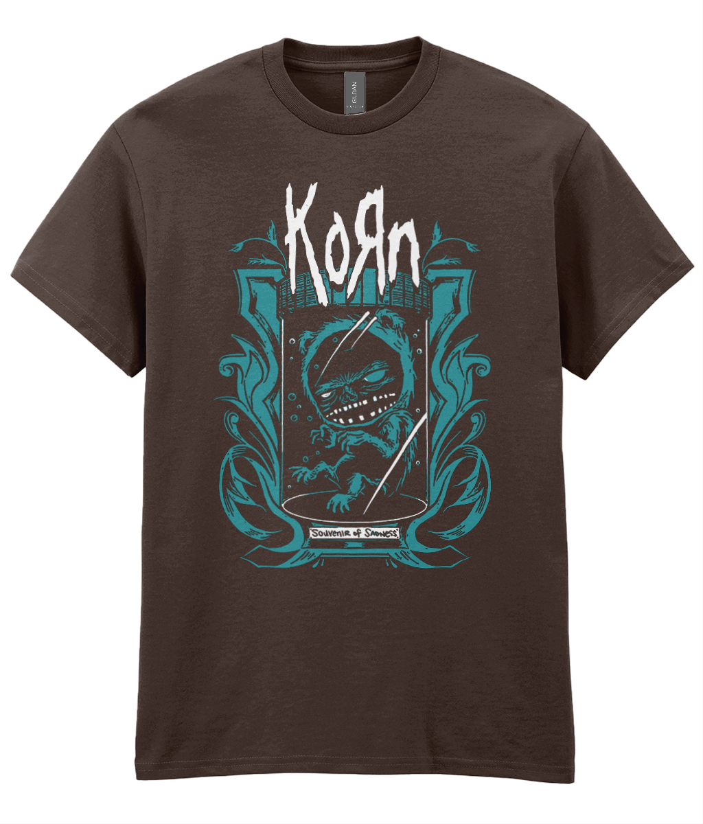 A dark brown short-sleeve graphic t-shirt featuring the band Korn with a stylized teal and white dragon illustration on the front.